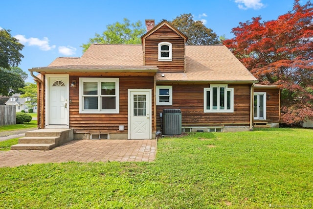 2851 Old Town Rd, Bridgeport, CT 06606 - back of property with a chimney, a lawn, a shingled roof, and entry steps