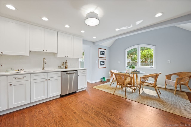 2851 Old Town Rd, Bridgeport, CT 06606 - kitchen featuring dishwasher, light countertops, white cabinetry, vaulted ceiling, and light wood finished floors