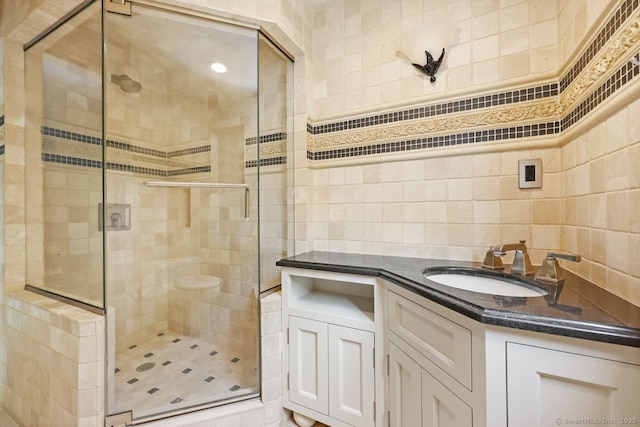 2851 Old Town Rd, Bridgeport, CT 06606 - bathroom featuring a stall shower, vanity, tasteful backsplash, and tile walls