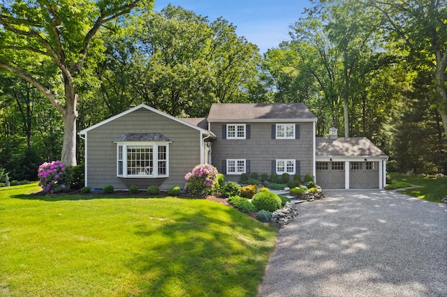 48 Blueberry Hill Rd, Weston, CT 06883 - view of front of home featuring a garage, a front yard, and asphalt driveway