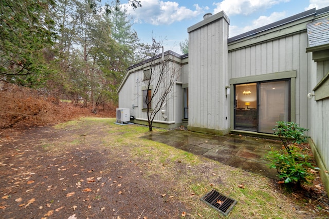 669 Heritage Vlg Unit B, Southbury, CT 06488 - back of property featuring a chimney and ac unit