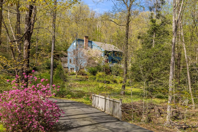 exterior space with a view of trees and aphalt driveway