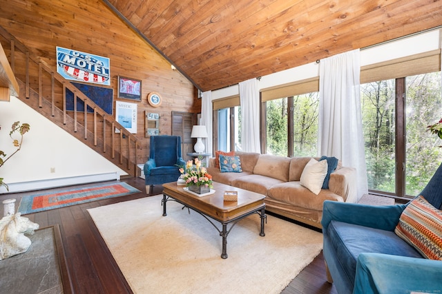 living area with wood walls, stairway, hardwood / wood-style flooring, wooden ceiling, and a baseboard radiator