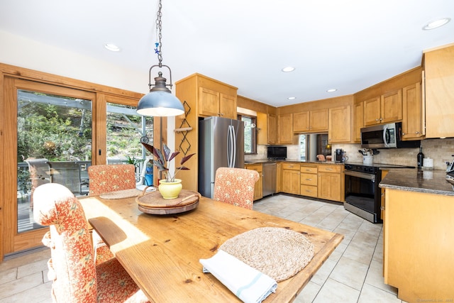 kitchen with appliances with stainless steel finishes, recessed lighting, decorative light fixtures, decorative backsplash, and light tile patterned floors