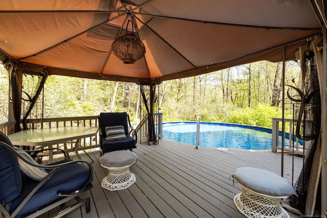 deck featuring a gazebo and an outdoor pool