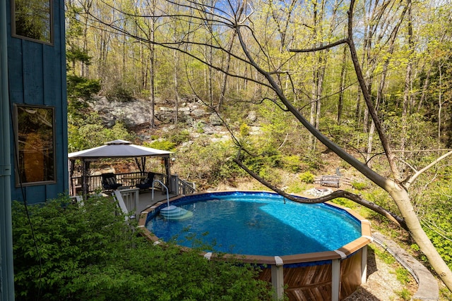 pool with a view of trees and a gazebo