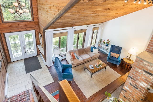 living area featuring french doors, wood ceiling, vaulted ceiling, and an inviting chandelier