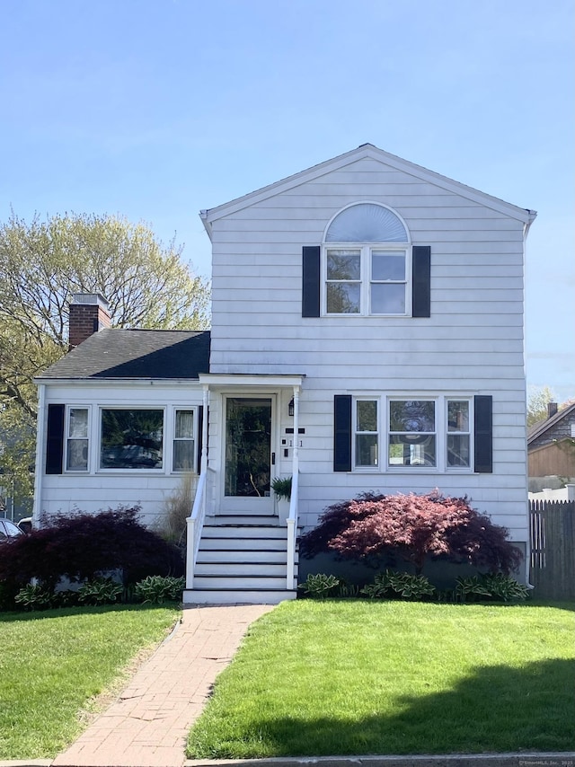 131 Vesper St, Fairfield, CT 06825 - traditional-style home with fence, a chimney, and a front yard