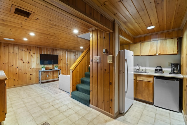131 Vesper St, Fairfield, CT 06825 - kitchen featuring freestanding refrigerator, wood walls, wooden ceiling, and light countertops