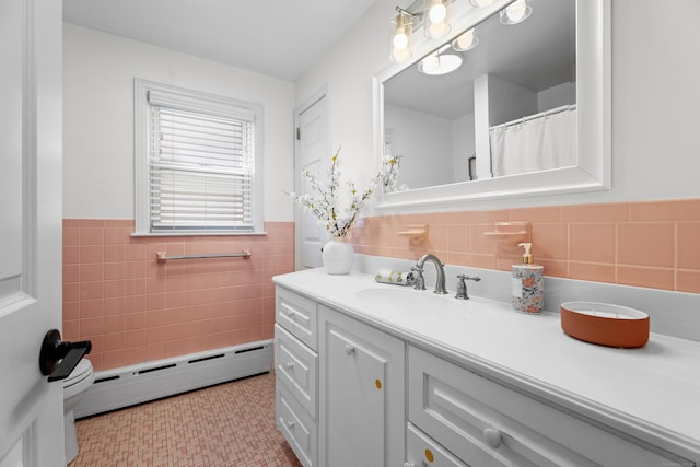 131 Vesper St, Fairfield, CT 06825 - bathroom with vanity, wainscoting, baseboard heating, and tile walls