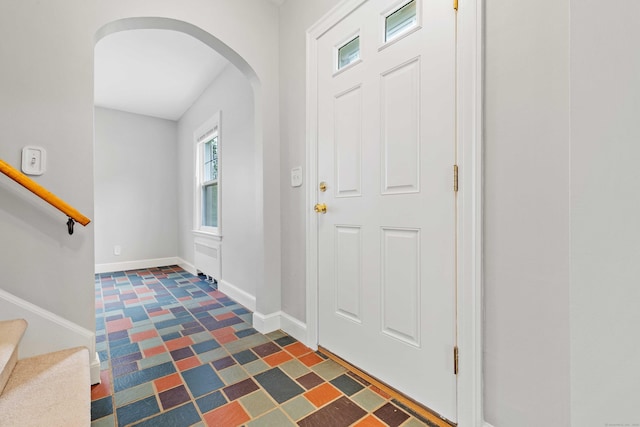 240 Barbara Rd, Middletown, CT 06457 - entryway featuring arched walkways, stairway, and dark flooring
