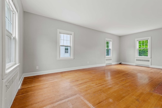 240 Barbara Rd, Middletown, CT 06457 - empty room featuring radiator heating unit and light wood-type flooring