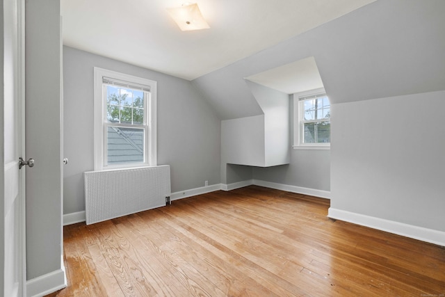 240 Barbara Rd, Middletown, CT 06457 - bonus room featuring radiator heating unit, hardwood / wood-style floors, vaulted ceiling, and plenty of natural light