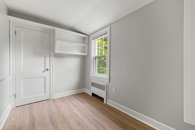 240 Barbara Rd, Middletown, CT 06457 - unfurnished bedroom with radiator heating unit, lofted ceiling, and light wood-style flooring