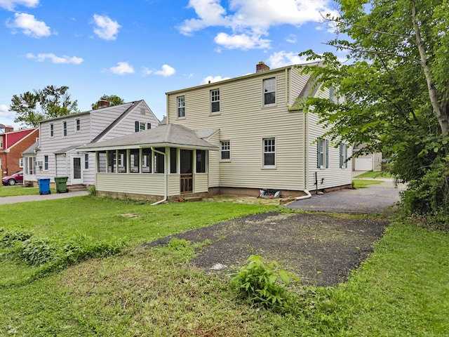 240 Barbara Rd, Middletown, CT 06457 - rear view of property with a sunroom, a chimney, a lawn, and entry steps