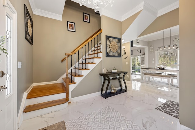 foyer featuring an inviting chandelier, stairs, marble finish floor, baseboards, and crown molding
