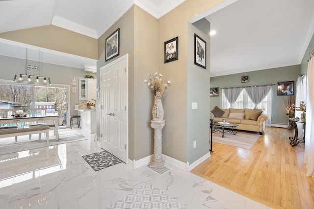 foyer with marble finish floor, ornamental molding, a baseboard heating unit, and baseboards