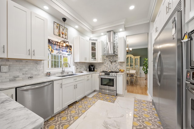 kitchen featuring a sink, stainless steel appliances, recessed lighting, ornamental molding, and wall chimney exhaust hood
