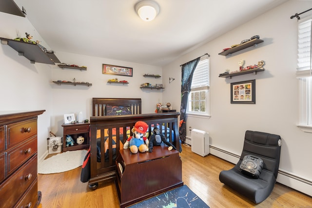 office area with baseboards, wood finished floors, and a baseboard radiator