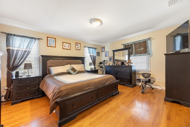 bedroom featuring visible vents and light wood-style flooring