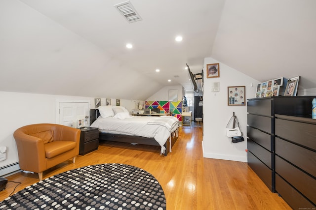bedroom with baseboards, visible vents, light wood-style floors, and lofted ceiling