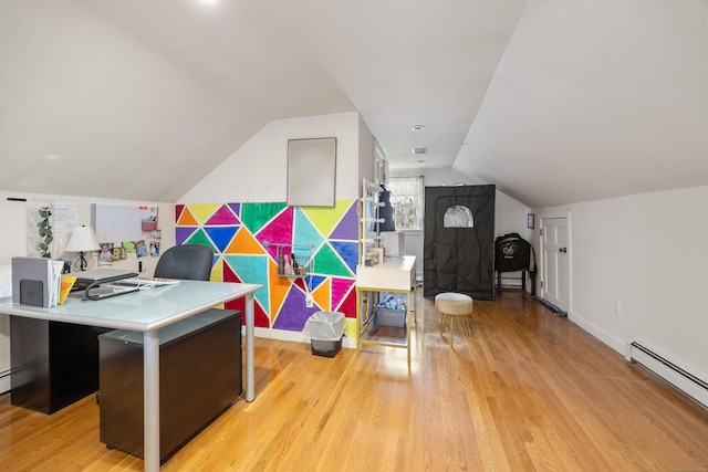 home office with baseboards, a baseboard radiator, lofted ceiling, and light wood-style floors