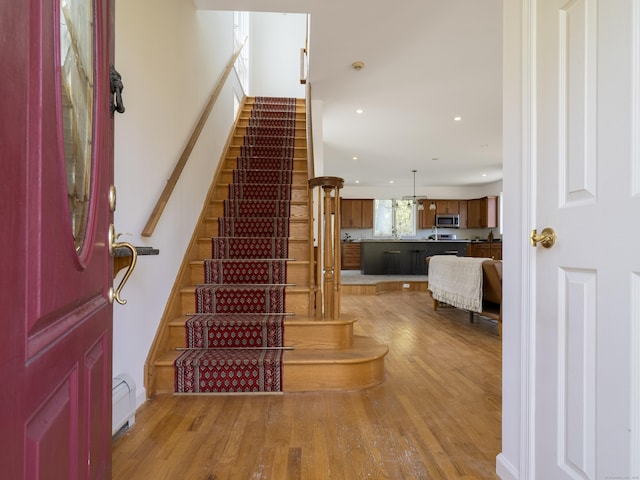 stairs featuring recessed lighting and wood finished floors