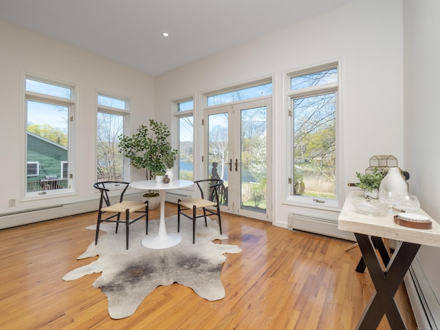 office space featuring a baseboard heating unit, recessed lighting, french doors, and wood finished floors