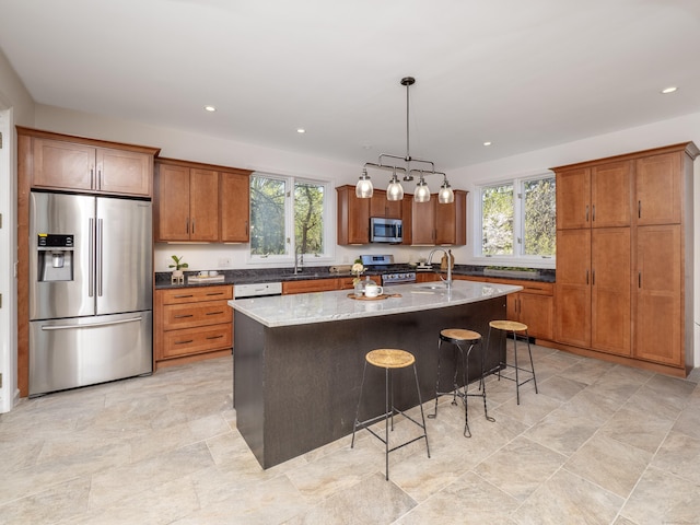 kitchen featuring brown cabinets, stainless steel appliances, and plenty of natural light