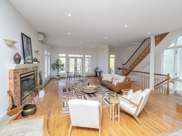 living room with a wealth of natural light, recessed lighting, and a wall mounted AC