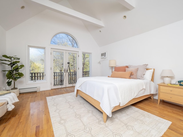 bedroom featuring wood finished floors, access to outside, baseboard heating, a wall mounted AC, and high vaulted ceiling
