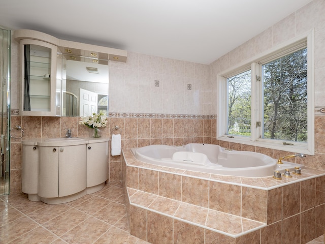 full bath featuring visible vents, tile walls, tile patterned floors, a garden tub, and vanity