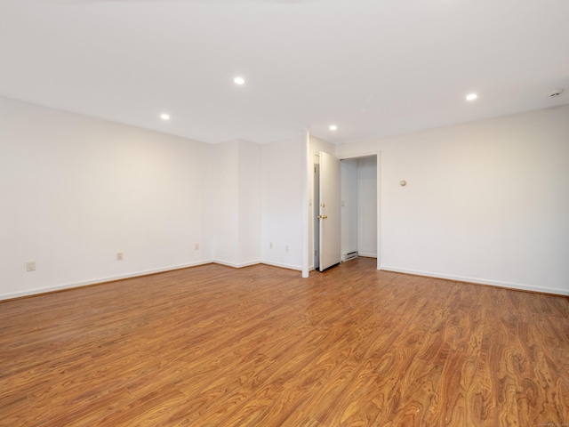 empty room featuring recessed lighting and light wood finished floors