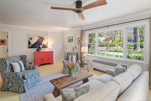 living room featuring radiator heating unit, baseboards, crown molding, and ceiling fan