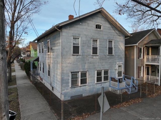 rear view of property featuring a chimney