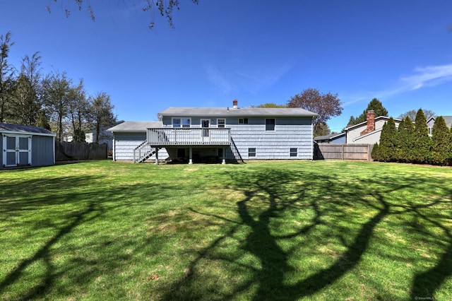back of property featuring a deck, an outbuilding, stairway, a shed, and a fenced backyard