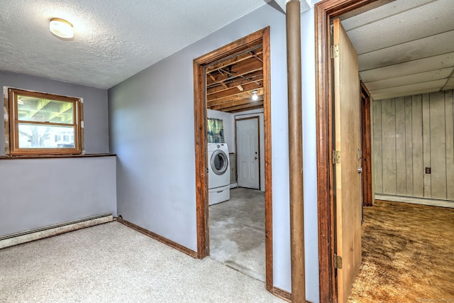 hallway featuring washer / dryer, carpet flooring, baseboards, baseboard heating, and a baseboard radiator