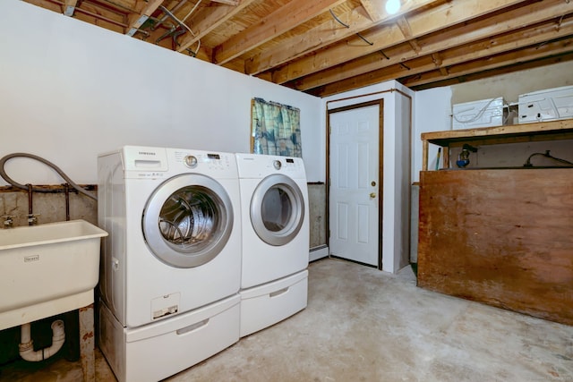 washroom with a sink, laundry area, and washer and dryer