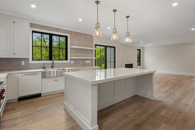 317 Park St, New Canaan, CT 06840 - kitchen featuring backsplash, a kitchen island, recessed lighting, white cabinetry, and light wood-style floors