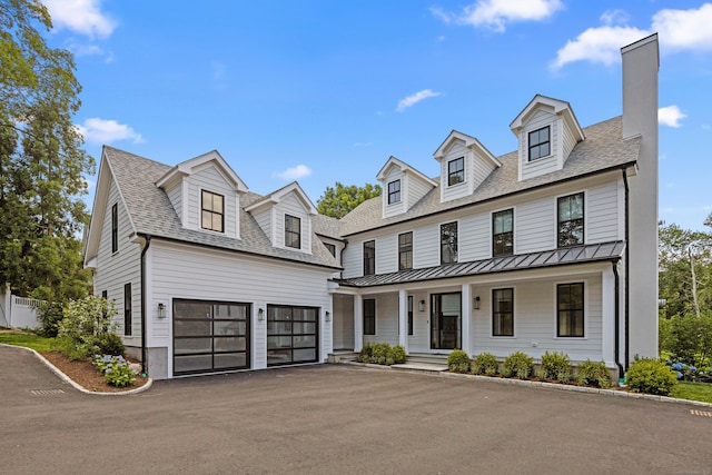 317 Park St, New Canaan, CT 06840 - view of front of property featuring covered porch, a standing seam roof, asphalt driveway, a garage, and a metal roof