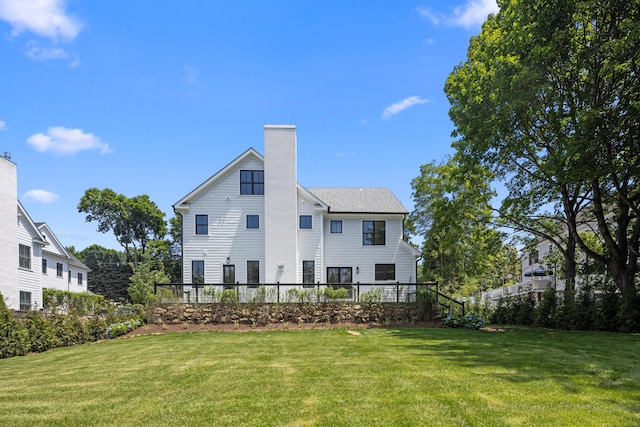 317 Park St, New Canaan, CT 06840 - back of house featuring a lawn and a chimney