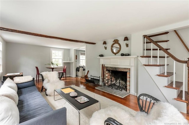 112 Easton Rd, Westport, CT 06880 - living area featuring wood finished floors, stairs, a fireplace with raised hearth, and a baseboard heating unit