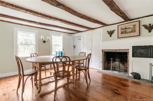 112 Easton Rd, Westport, CT 06880 - dining room with beamed ceiling, hardwood / wood-style flooring, and a fireplace with flush hearth