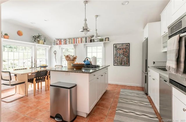 112 Easton Rd, Westport, CT 06880 - kitchen with a center island, light tile patterned floors, healthy amount of natural light, stainless steel appliances, and lofted ceiling