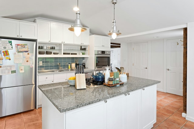 112 Easton Rd, Westport, CT 06880 - kitchen with appliances with stainless steel finishes, light tile patterned floors, a center island, and white cabinetry
