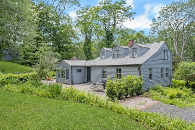 112 Easton Rd, Westport, CT 06880 - back of house featuring a chimney, a patio, a yard, and view of wooded area