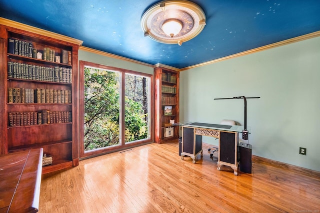 unfurnished office featuring ornamental molding and wood finished floors