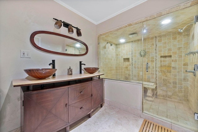 full bath featuring double vanity, a sink, a stall shower, and ornamental molding