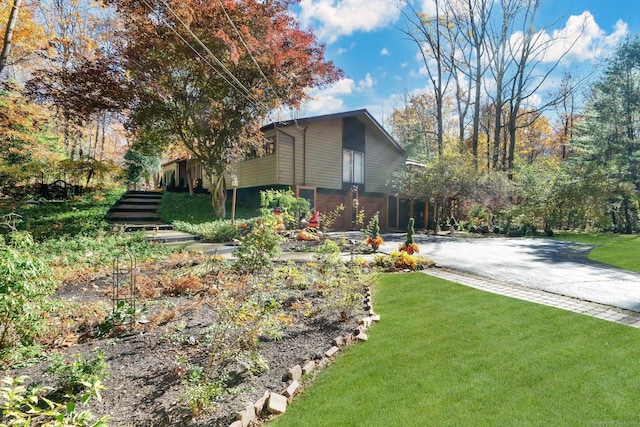 view of side of property with a lawn