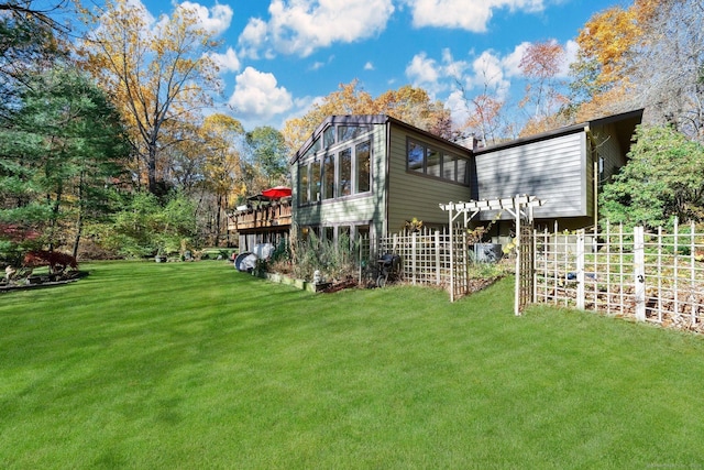 view of yard with a deck and fence